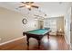 Game room with a pool table, hardwood floors, and cozy sitting area at 3365 Buffington Ln, Cumming, GA 30040