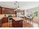 Gourmet kitchen featuring granite countertops, stainless steel appliances, and dark wood cabinetry at 3365 Buffington Ln, Cumming, GA 30040