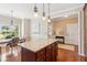 Open-concept kitchen with an island, a view to the foyer, and an adjacent breakfast area at 3365 Buffington Ln, Cumming, GA 30040