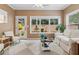 Inviting sun room with large windows and a cozy sitting area at 3365 Buffington Ln, Cumming, GA 30040