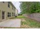 An open backyard featuring a concrete patio and a stone retaining wall at 3399 Lake Frg, Fairburn, GA 30213