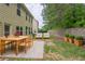 A furnished backyard with a patio seating arrangement and manicured potted plants at 3399 Lake Frg, Fairburn, GA 30213
