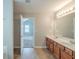 Bathroom featuring double sinks and vanity with an open door to the rest of the house at 3399 Lake Frg, Fairburn, GA 30213