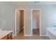 Bathroom featuring tiled floors, a bathtub, toilet room and a separate walk-in closet at 3399 Lake Frg, Fairburn, GA 30213