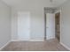 Carpeted bedroom with 2 doors and neutral colored walls at 3399 Lake Frg, Fairburn, GA 30213