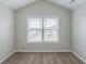 Bedroom with vaulted ceilings, window, neutral carpet and light gray paint at 3399 Lake Frg, Fairburn, GA 30213