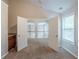 Bedroom featuring open doorway, neutral carpet, mini bar and large window at 3399 Lake Frg, Fairburn, GA 30213
