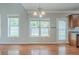 Bright open dining area with hardwood floors, large windows, and a door to the backyard at 3399 Lake Frg, Fairburn, GA 30213