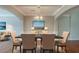 Elegant dining room featuring hardwood floors, modern lighting, and seating for six at 3399 Lake Frg, Fairburn, GA 30213