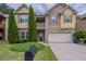 Charming two-story home featuring a stone facade, attached two-car garage and a well-manicured lawn at 3399 Lake Frg, Fairburn, GA 30213