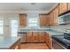 Bright kitchen with ample countertop space, wooden cabinetry, stainless steel appliances, and a view at 3399 Lake Frg, Fairburn, GA 30213