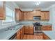 Well-lit kitchen features wooden cabinets, stainless steel appliances, and laminate countertops at 3399 Lake Frg, Fairburn, GA 30213