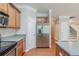 Kitchen view of stainless steel appliances and hardwood floors, with staircase and hallway in background at 3399 Lake Frg, Fairburn, GA 30213