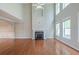 Spacious living room with hardwood floors, fireplace, and tall windows for natural light at 3399 Lake Frg, Fairburn, GA 30213