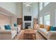 Cozy living room features a fireplace, bookshelves, neutral furniture, and bright natural light at 3399 Lake Frg, Fairburn, GA 30213