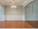 Spacious living room with hardwood floors, wainscoting, archway and elegant lighting at 3399 Lake Frg, Fairburn, GA 30213
