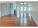 Open-concept living room with fireplace, gleaming hardwood floors, and abundant natural light at 3399 Lake Frg, Fairburn, GA 30213