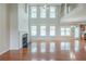 Bright open living room with a fireplace, hardwood floors, and tall windows for natural light at 3399 Lake Frg, Fairburn, GA 30213