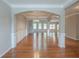 Open-concept living room featuring hardwood floors, an archway, and coffered ceilings at 3399 Lake Frg, Fairburn, GA 30213
