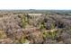 Aerial view of the property and surrounding wooded area with house address visible at 4568 Oswood Ct, Tucker, GA 30084