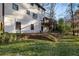 Exterior view of the home's backyard and upper deck, with stairs leading down to the lawn at 4568 Oswood Ct, Tucker, GA 30084