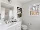 Bright bathroom featuring white finishes, a shower with unique tiling, and a serene view at 4568 Oswood Ct, Tucker, GA 30084