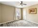 Neutral bedroom featuring carpeted floors, a ceiling fan, and a window with natural light at 4568 Oswood Ct, Tucker, GA 30084