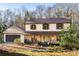 Charming two-story home features stone accents, a covered porch with wood railings, and a well-maintained front yard at 4568 Oswood Ct, Tucker, GA 30084