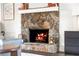 Close-up of the stunning stone fireplace in the living room, featuring decorative items at 4568 Oswood Ct, Tucker, GA 30084