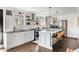 Beautiful kitchen with white cabinets, stainless steel appliances, a center island, and hardwood floors at 4568 Oswood Ct, Tucker, GA 30084