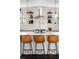 Bright kitchen featuring a center island with seating, stainless steel appliances, and floating shelves at 4568 Oswood Ct, Tucker, GA 30084