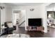 Open concept living room showcasing modern decor and hardwood flooring, open to dining and stairway at 4568 Oswood Ct, Tucker, GA 30084
