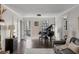 Bright living room with hardwood floors, a grand piano, and access to an outdoor deck at 4568 Oswood Ct, Tucker, GA 30084