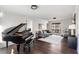 Spacious living room featuring a grand piano, hardwood floors, and comfortable seating at 4568 Oswood Ct, Tucker, GA 30084