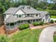 Aerial view of beautiful two-story home featuring lush landscaping, and a circular driveway at 5102 Chastleton Dr, Stone Mountain, GA 30087
