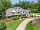 Aerial view of beautiful home featuring lush landscaping, and a circular driveway at 5102 Chastleton Dr, Stone Mountain, GA 30087