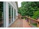 Wooden back deck with black railing and large glass doors at 5102 Chastleton Dr, Stone Mountain, GA 30087
