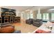 Finished basement features a bar with custom shelving and seating plus a lounge area with lots of natural light at 5102 Chastleton Dr, Stone Mountain, GA 30087