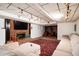 Finished basement with brick fireplace and a large sofa at 5102 Chastleton Dr, Stone Mountain, GA 30087