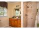 Bathroom featuring vanity with double sinks and a walk-in shower with a tile surround at 5102 Chastleton Dr, Stone Mountain, GA 30087