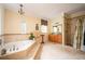 Bright bathroom with jacuzzi tub, walk-in shower, and vanity at 5102 Chastleton Dr, Stone Mountain, GA 30087