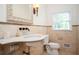 Elegant bathroom features a marble sink, ornate mirror, and natural light, creating a serene and luxurious experience at 5102 Chastleton Dr, Stone Mountain, GA 30087