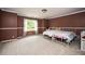 Bedroom with white metal beds, carpet flooring, and a large window at 5102 Chastleton Dr, Stone Mountain, GA 30087