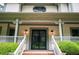 Charming home entrance with decorative columns, address display, and manicured landscaping at 5102 Chastleton Dr, Stone Mountain, GA 30087