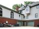 Exterior view of home featuring two garage doors, brick foundation, and white siding at 5102 Chastleton Dr, Stone Mountain, GA 30087