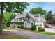 Spacious two-story home with a three-car garage, well-maintained landscaping, and a brick driveway at 5102 Chastleton Dr, Stone Mountain, GA 30087