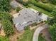 Beautiful home featuring a sprawling roofline, mature trees, and a meticulously kept lawn at 5102 Chastleton Dr, Stone Mountain, GA 30087