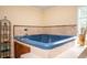 Close-up of the jacuzzi tub with tile surround and elegant fixtures at 5102 Chastleton Dr, Stone Mountain, GA 30087