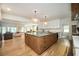 This kitchen features an island with a light stone countertop and wood base, plus modern pendant lighting at 5102 Chastleton Dr, Stone Mountain, GA 30087