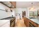 Gourmet kitchen features a premium gas range, custom cabinets, and a sink with marble countertops at 5102 Chastleton Dr, Stone Mountain, GA 30087
